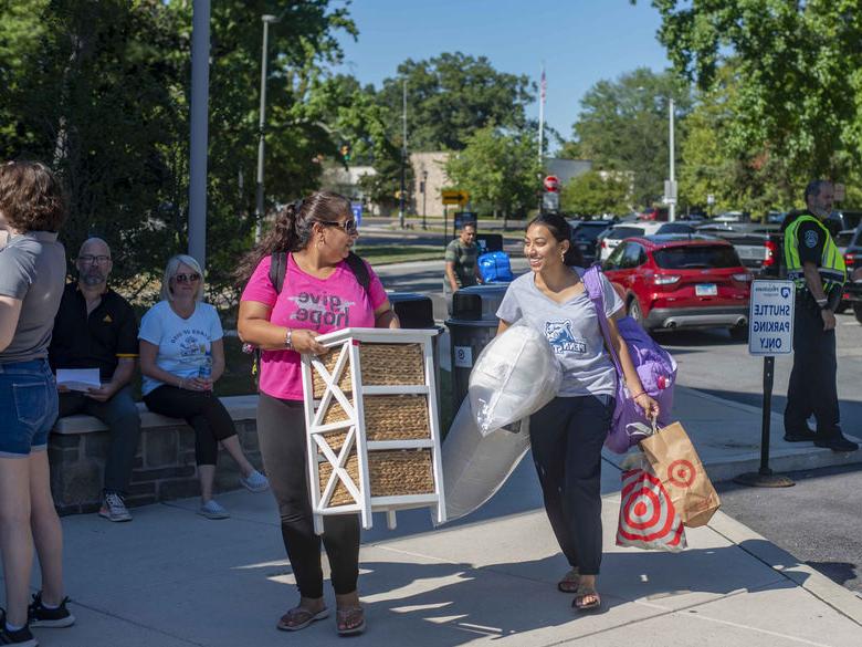 student moving furniture into lions gate
